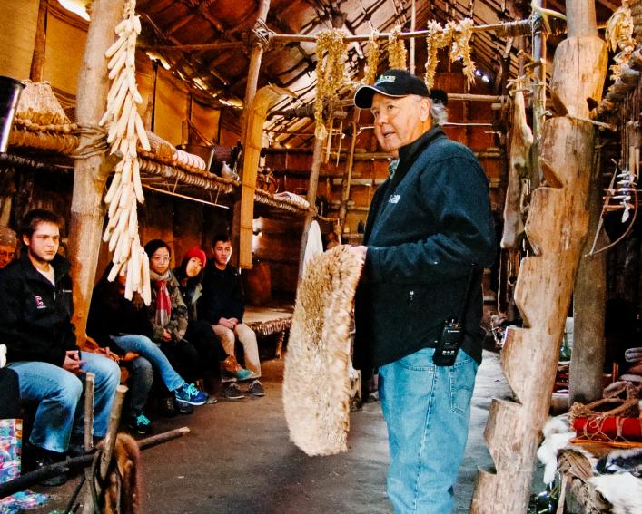 Akwe：kon居民在Ganondagan参加了一个重建的龙屋。